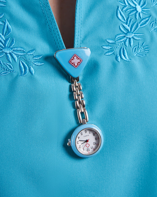 Reloj prendedor cruz triangular