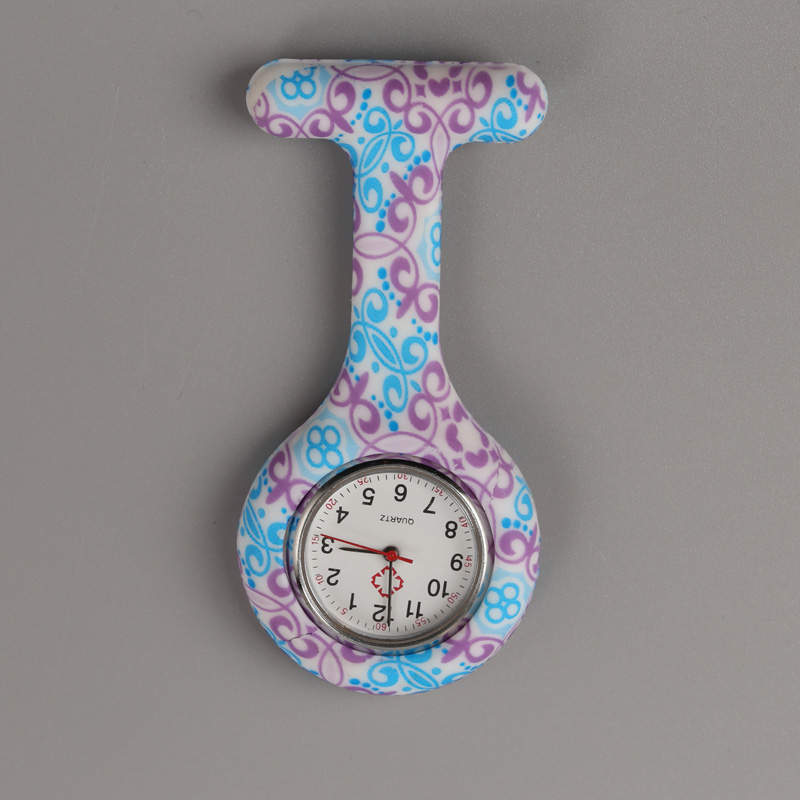 Reloj prendedor morado con turquesa